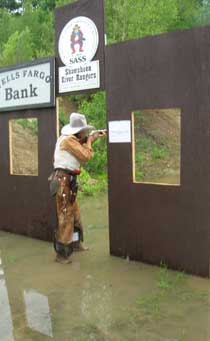 English Bev shooting rifle in a large puddle.